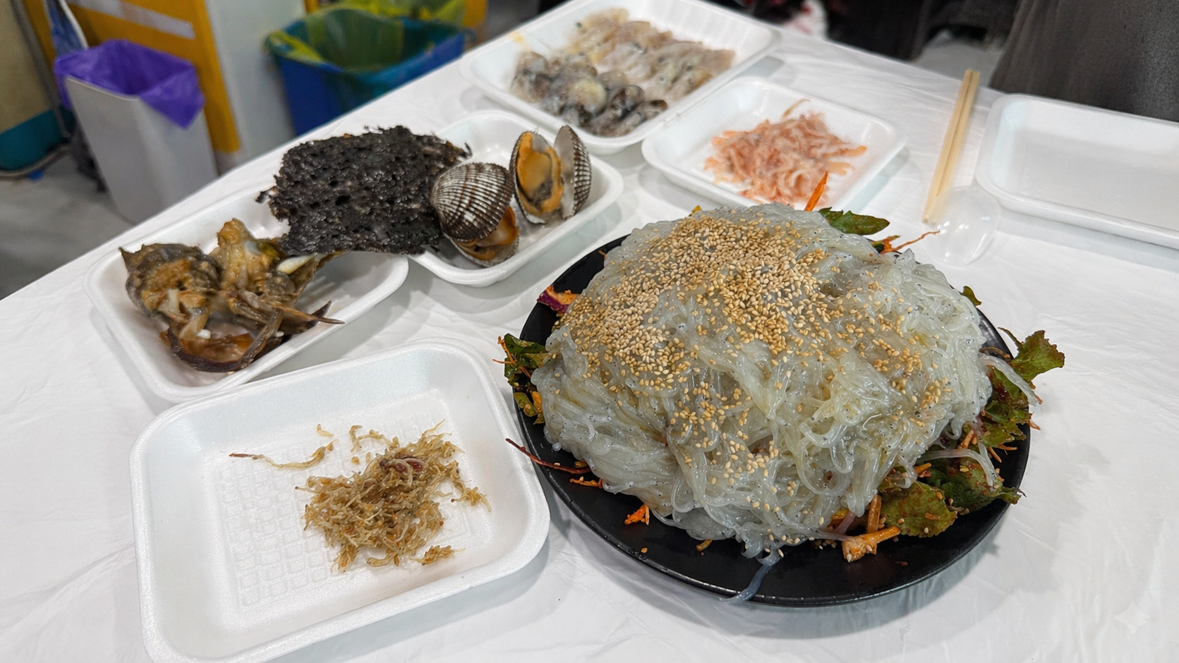 Silchi sashimi served with a full spread of side dishes