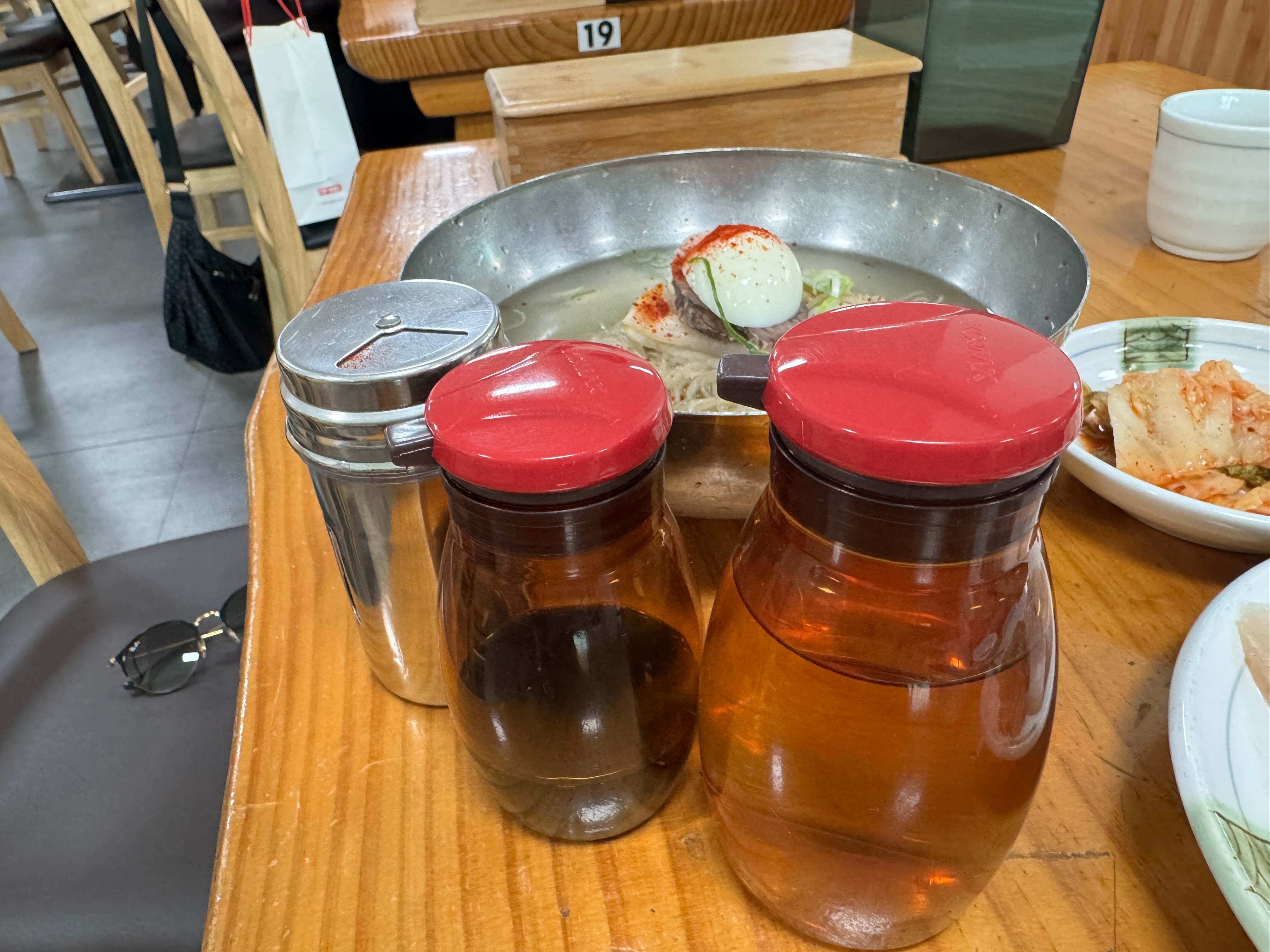 Table condiments served with Pyeongyang Naengmyeon